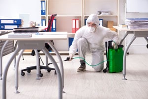 MOM employee disinfecting a classroom at a school using our cleaning services