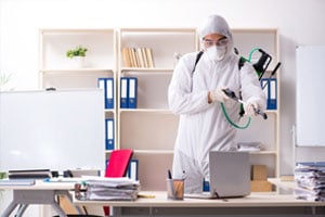 MOM employee disinfecting an office at a business using our cleaning services