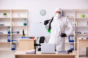 MOM employee disinfecting a classroom at a school using our cleaning services